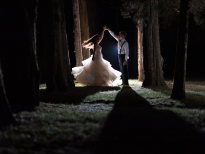 Bride and groom dancing in the woods after their wedding