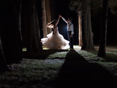 Bride and groom dancing in the woods after their wedding